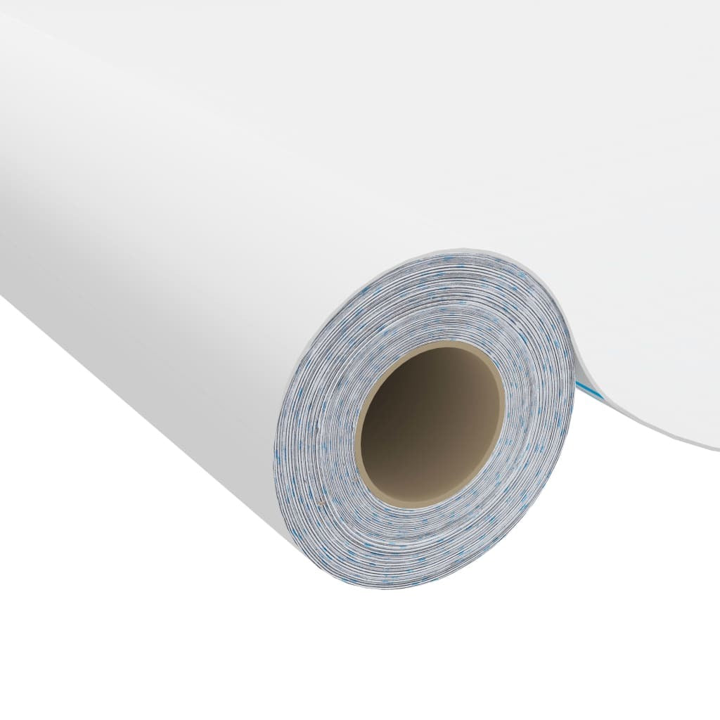 White self-adhesive vinyl film being applied to furniture surface demonstrating easy peel-and-stick installation process