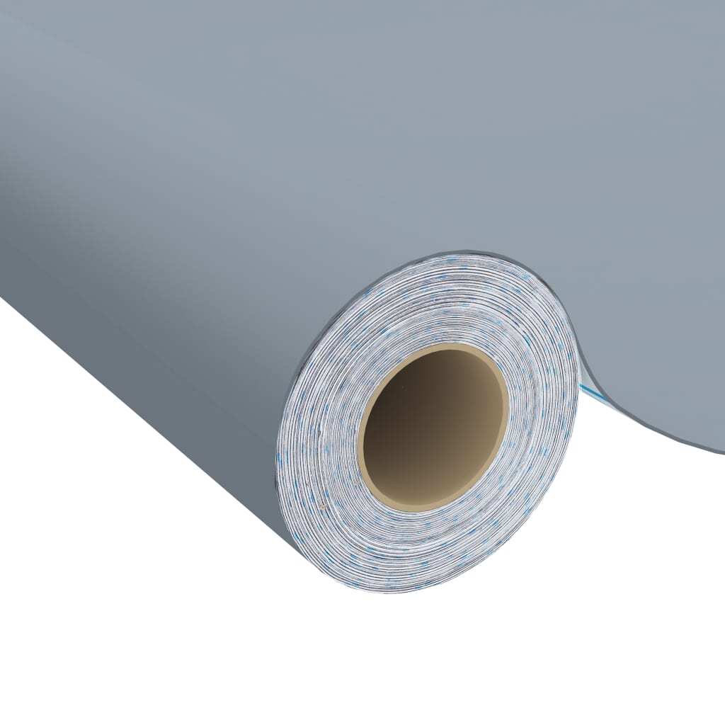 Gray self-adhesive vinyl film being applied to furniture surface demonstrating easy peel-and-stick waterproof installation