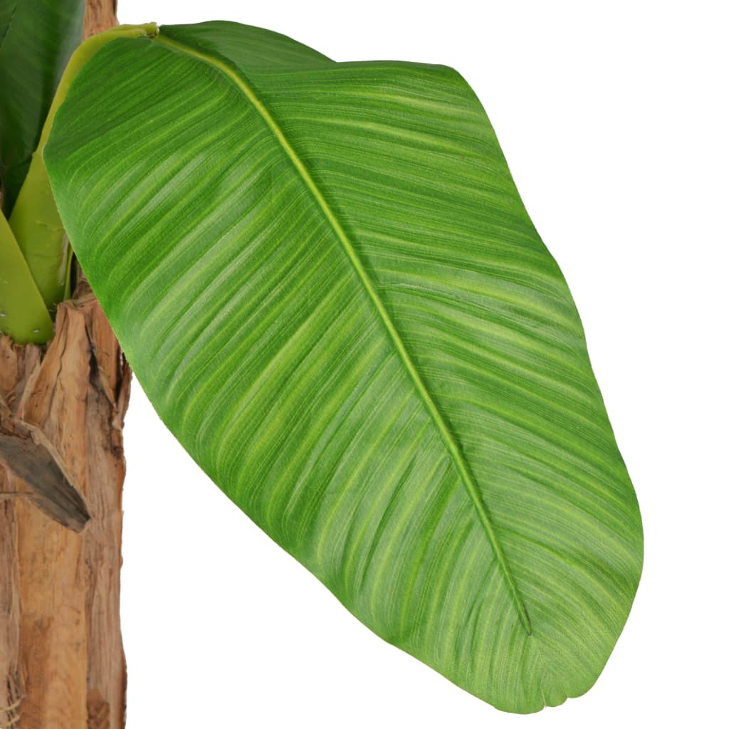 Large artificial plant with green foliage and wooden stems close-up showing realistic leaves and decorative details