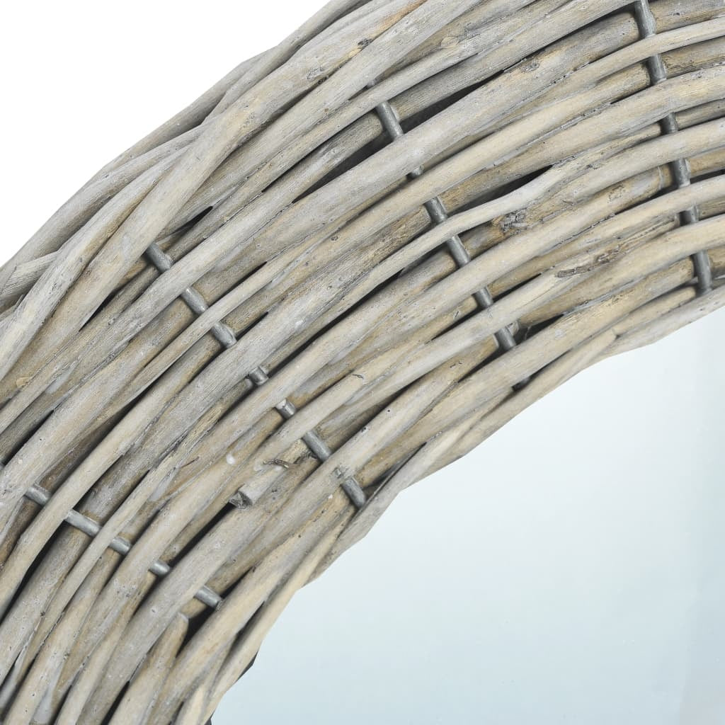 Vintage round rattan mirror installed in entryway foyer showing coastal rustic boho interior design style