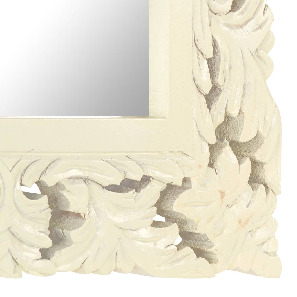 Side angle of solid mango wood mirror showing depth of hand-carved pattern and white finish that enhances textured details