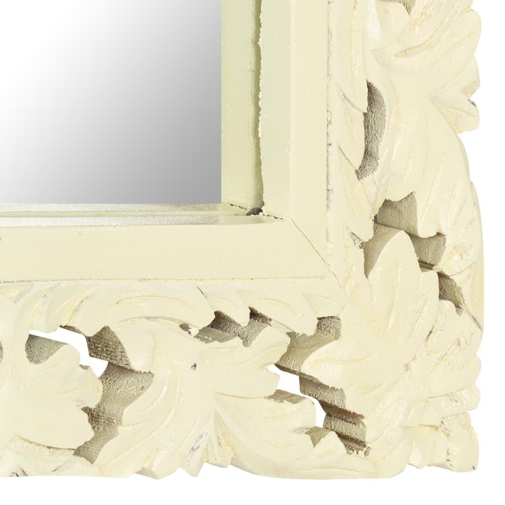 Decorative mirror with intricate white frame on a white background