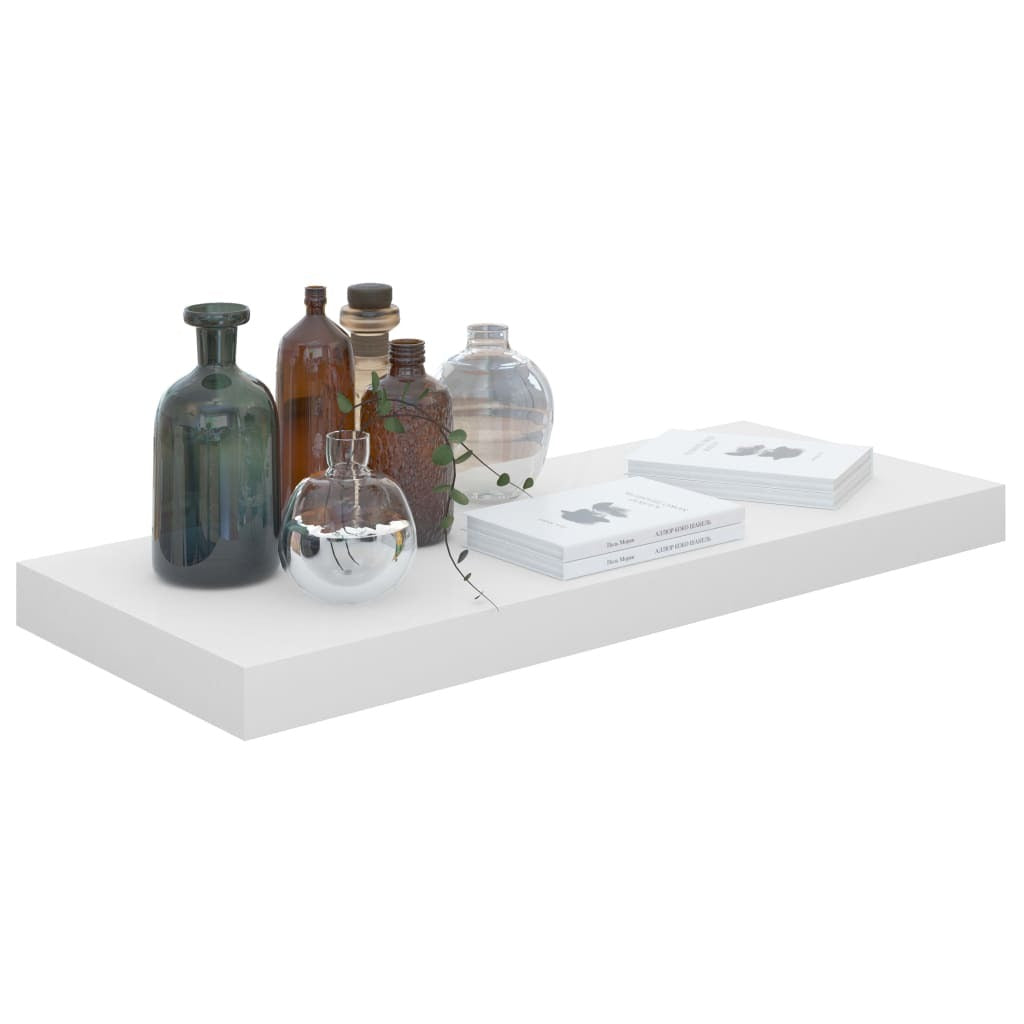 Close-up of single high gloss white floating shelf showing clean minimalist design