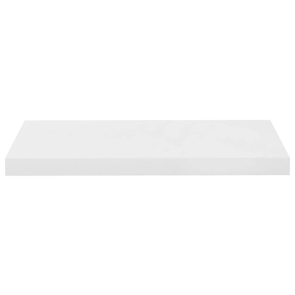 High gloss white floating shelf displaying books plants and modern accessories