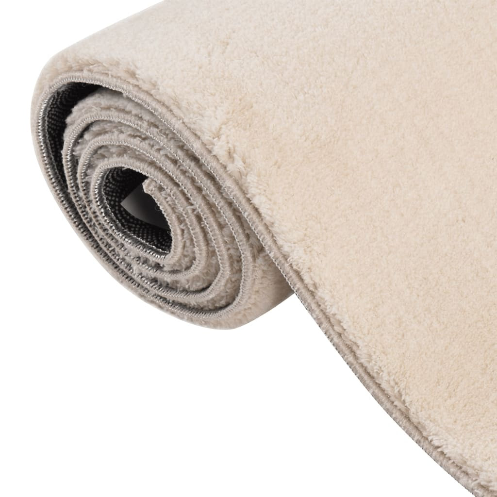 Close-up of fluffy beige rug texture showing soft polyester fibers