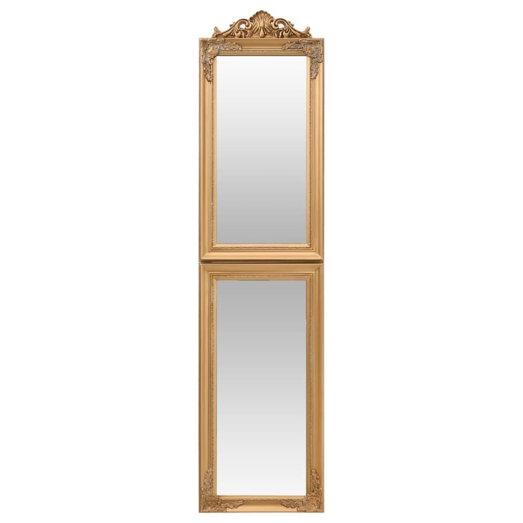 Elegant gold standing mirror close-up displaying baroque embellishments and polished glass surface