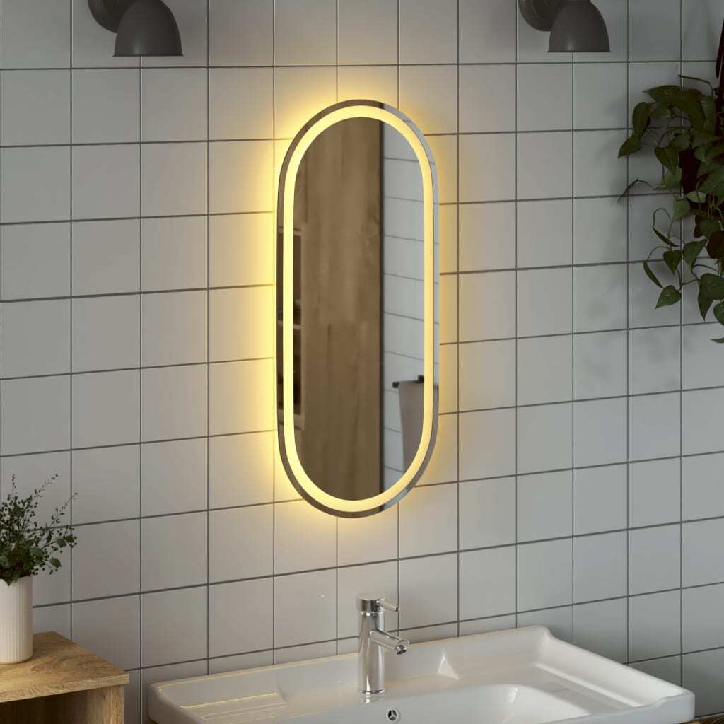 Waterproof oval LED mirror 31.5 x 15.7 inches installed in modern bathroom vanity area