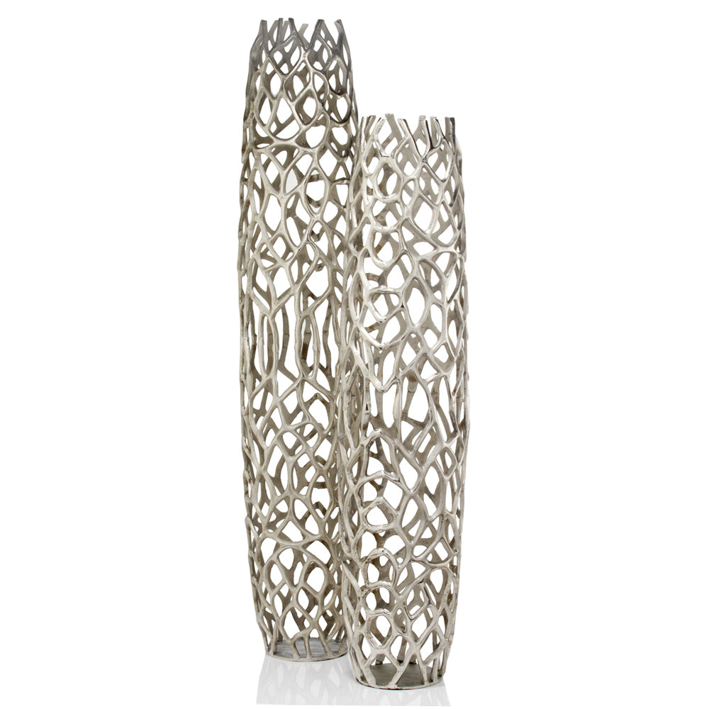 Side view of tall silver aluminum floor vase showing cylinder shape and contemporary twigs texture