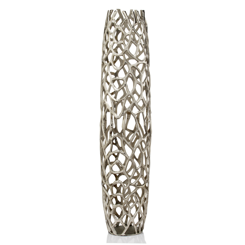 Close-up of silver aluminum finish on modern cylinder floor vase with textured twigs design