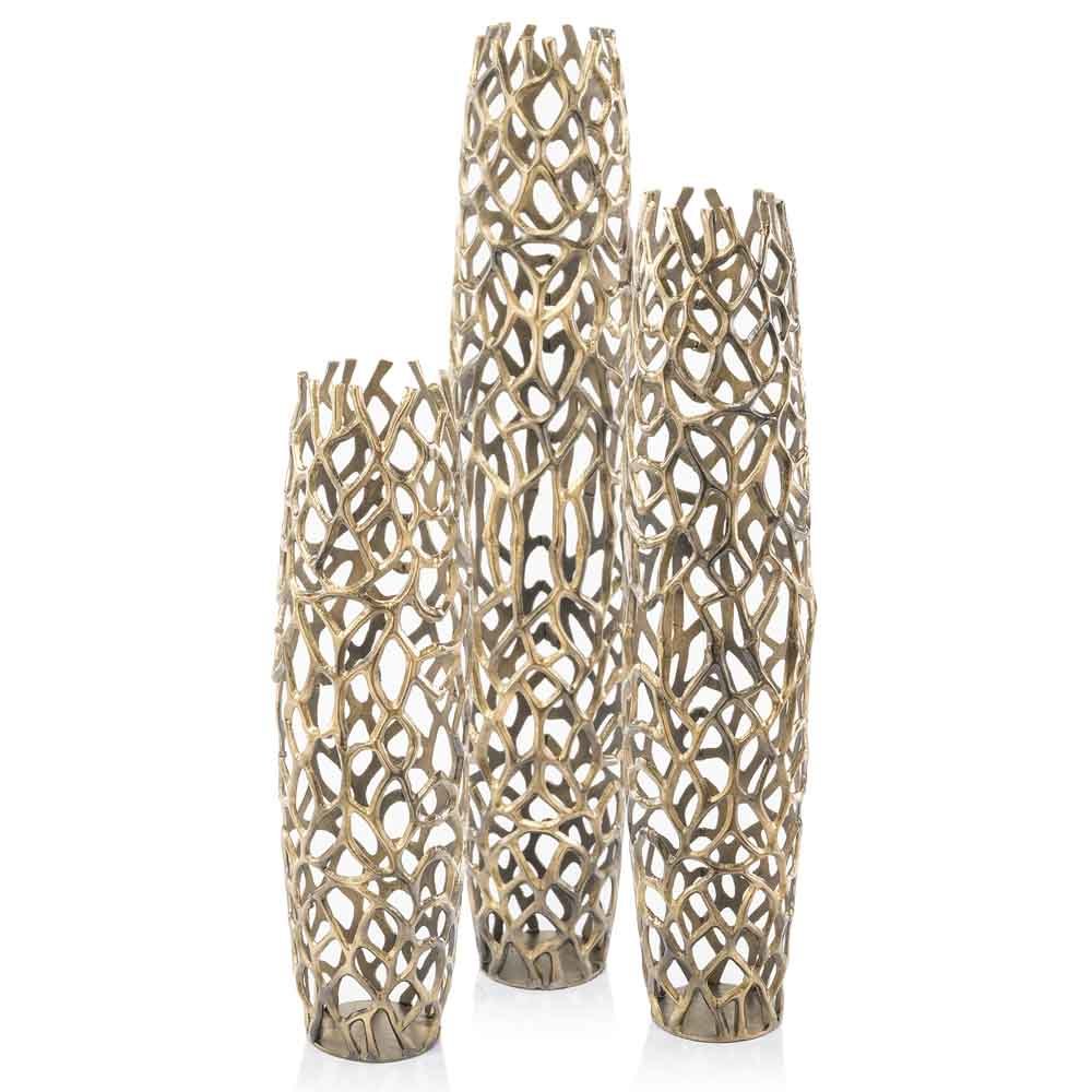 Close-up detail of gold twigs pattern on aluminum floor vase, luxurious metallic finish with organic texture design