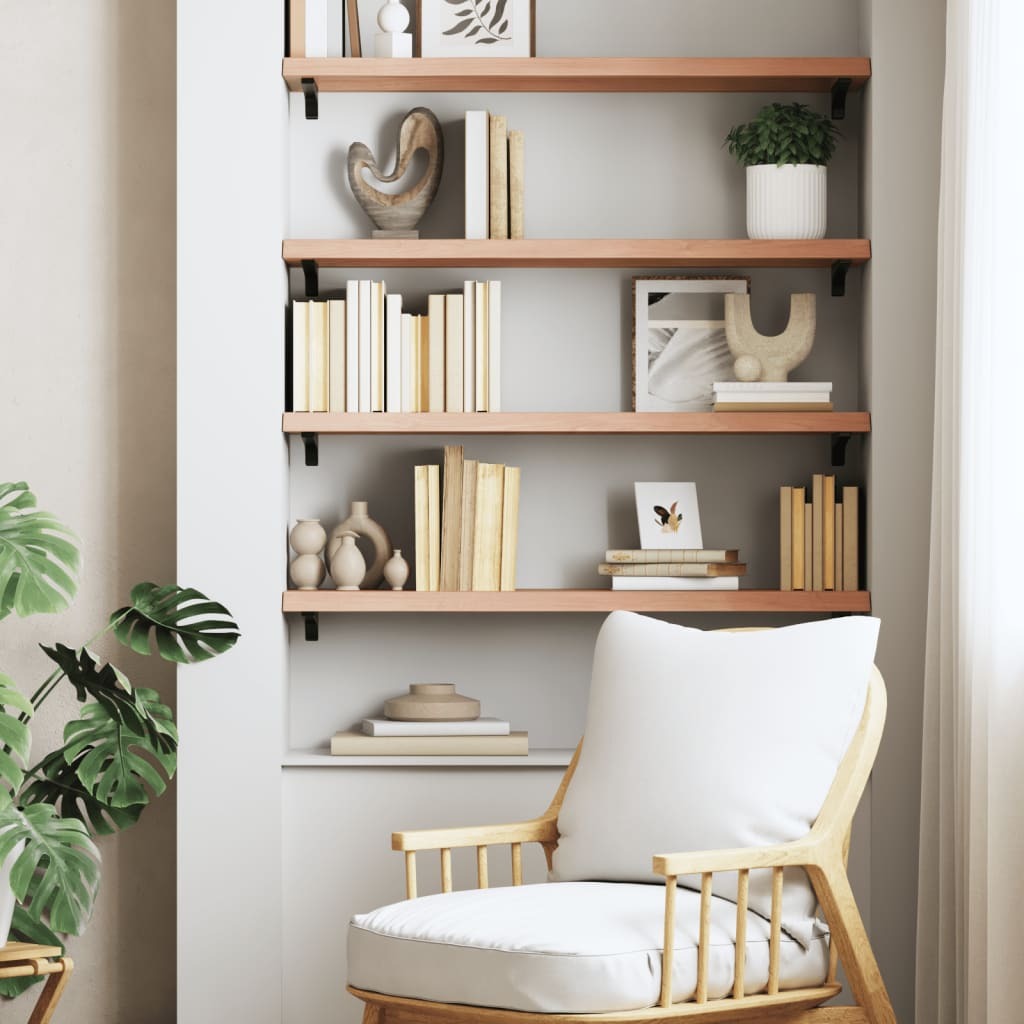 Oak wood floating shelf mounted on wall displaying books and decorative items
