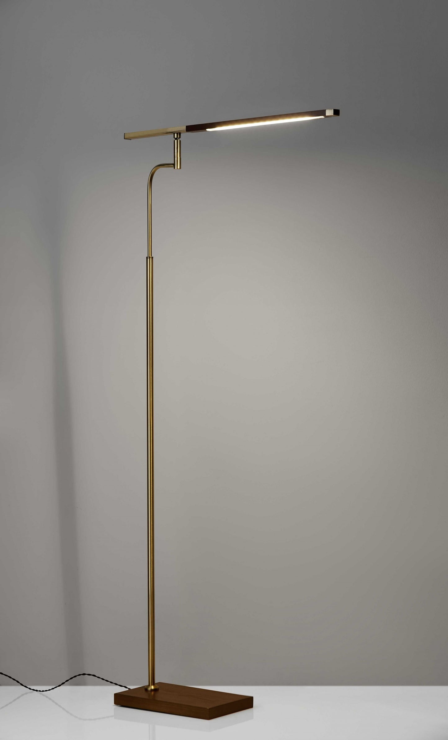 Side angle of 63-inch metal floor lamp demonstrating adjustable positioning and stable base design