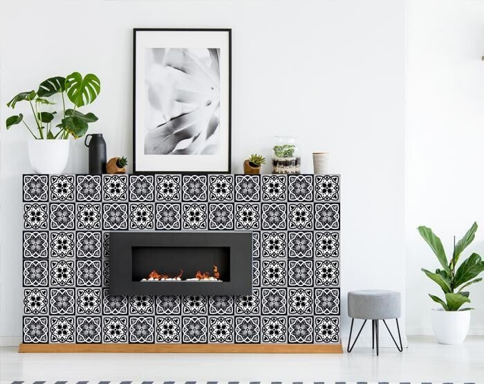 Bathroom accent wall featuring black white gray peel and stick tiles as decorative element