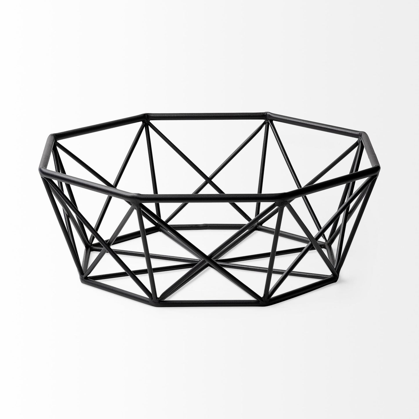 Side view of black metal geometric bowl with openwork design creating light and shadow effects