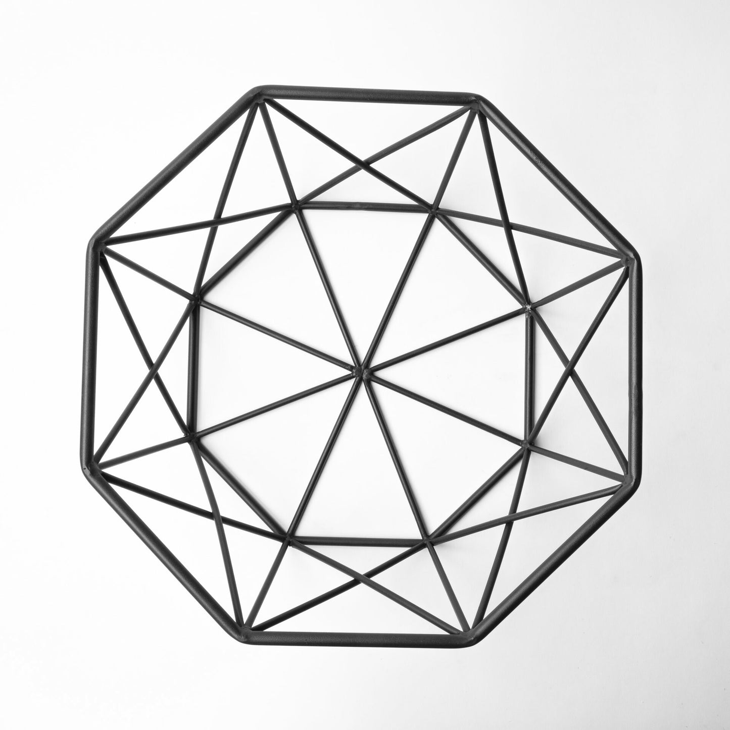 Black geometric centerpiece bowl detail showing premium metal construction and modern craftsmanship