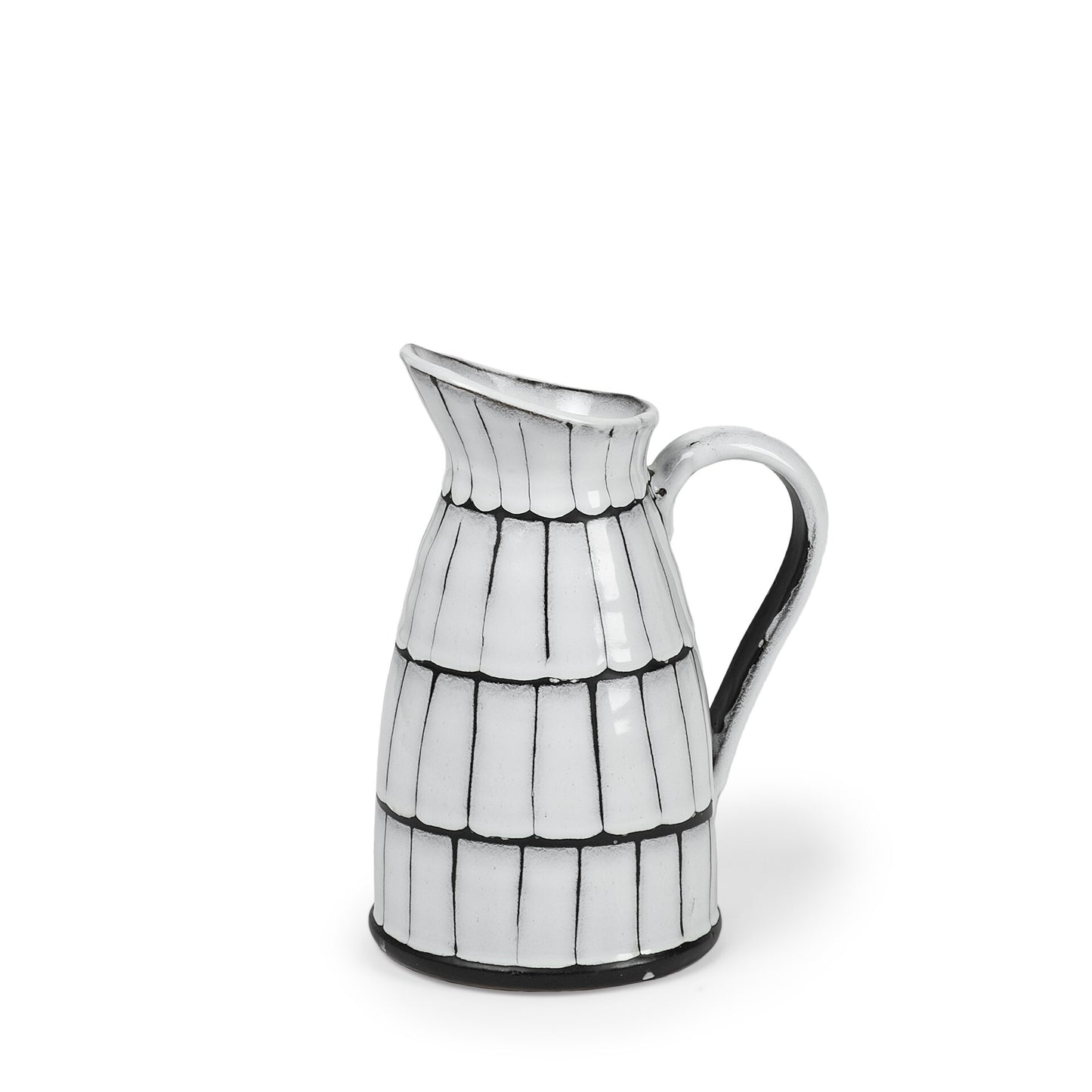 Close-up of artisan glaze pattern on white and black ceramic pitcher showing unique handcrafted details