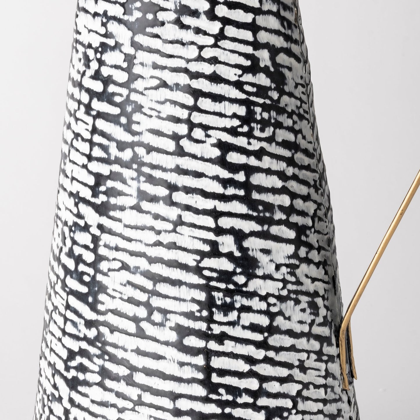 Black white patterned pitcher vase showing solid metal construction and contemporary style