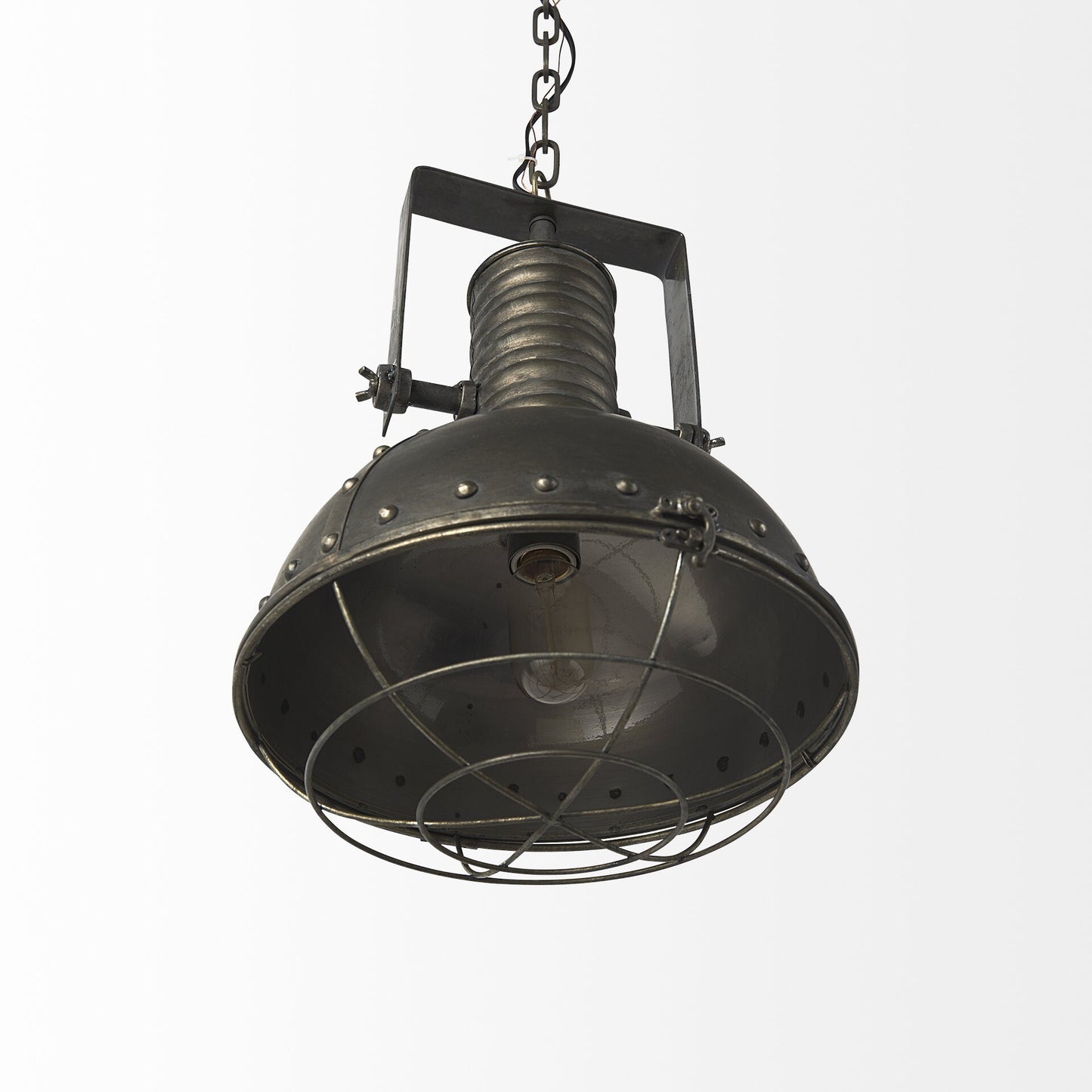 Industrial caged black metal hanging light illuminated showing warm lighting