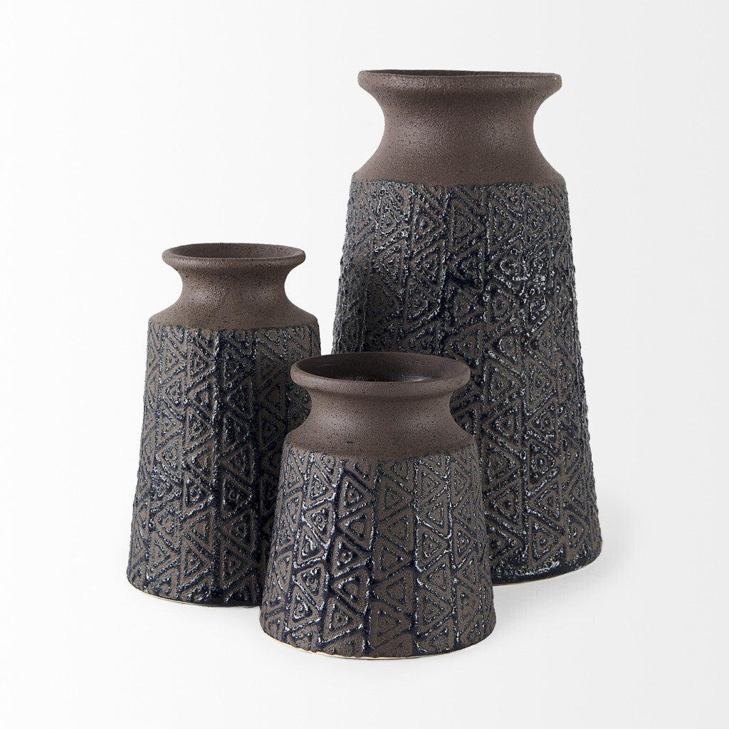 Detail of speckled brown finish and triangle pattern on tribal ceramic vase, artisan crafted boho home accent