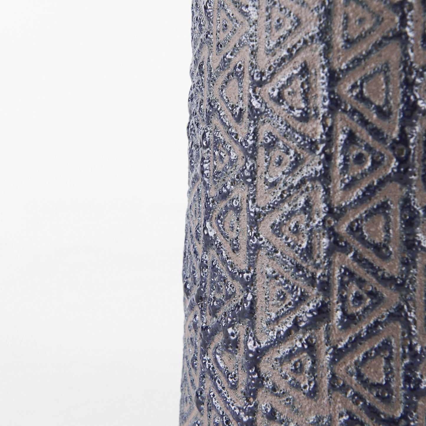 Brown ceramic tribal vase showing embossed black geometric details, unique bohemian statement piece for table or shelf