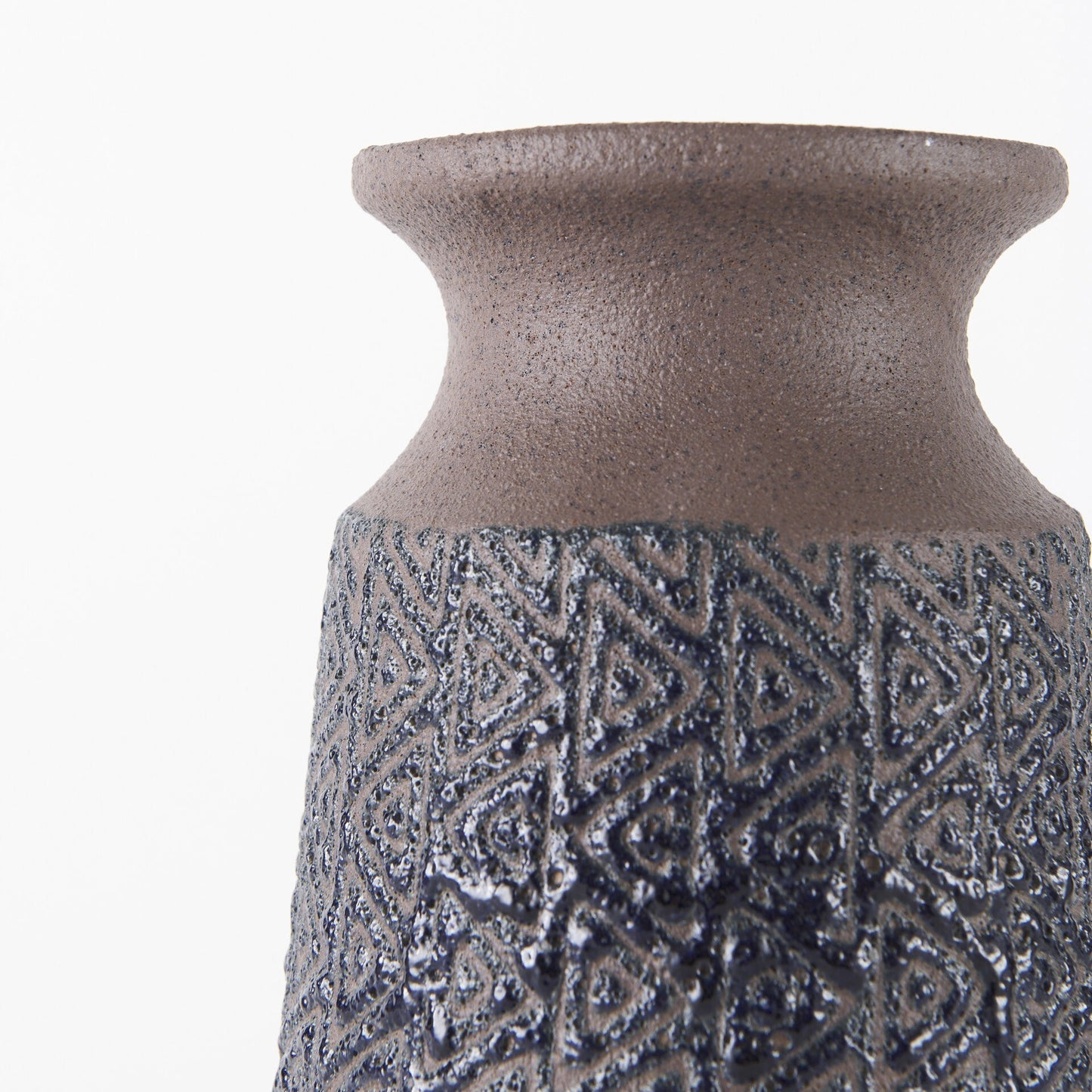 Full view of 11 inch brown and blue tribal ceramic vase showing complete embossed pattern and artisan craftsmanship