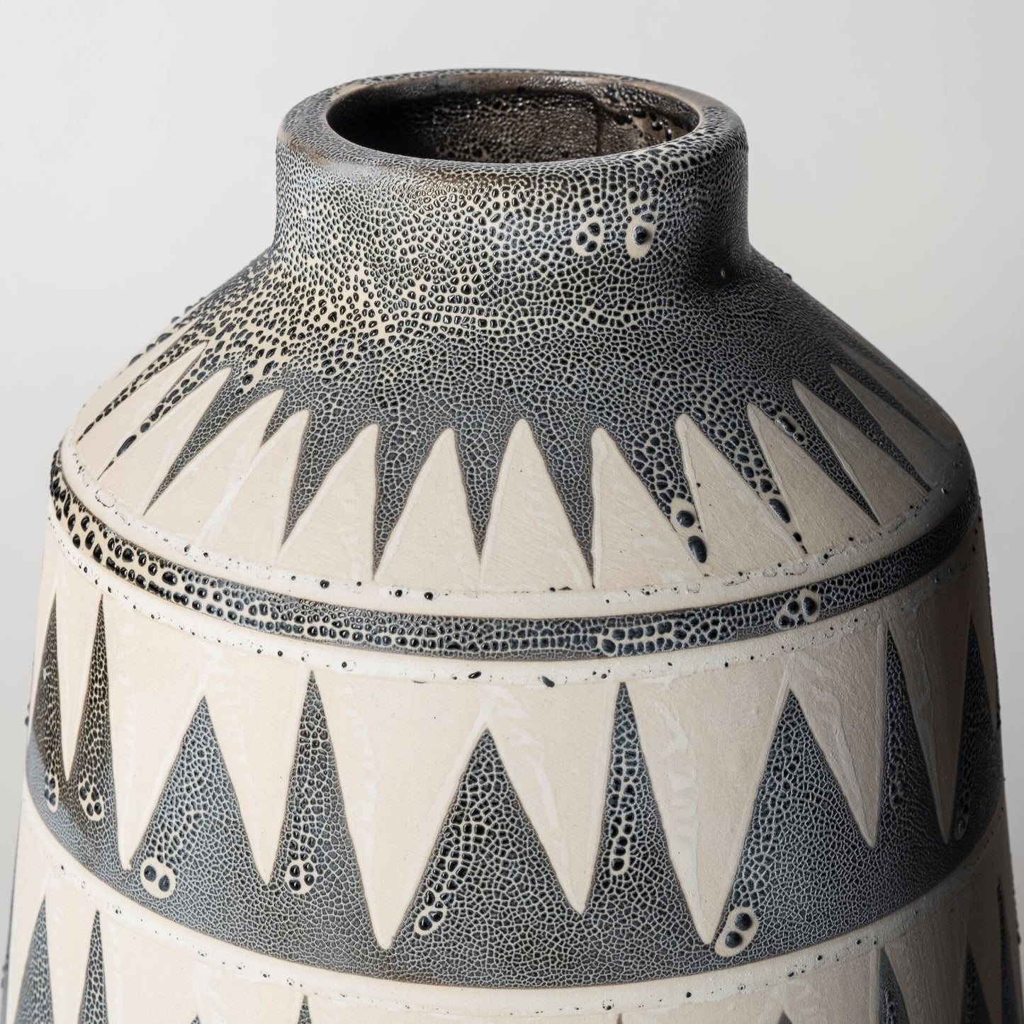 Modern geometric vase displaying triangle zigzag design and sophisticated silhouette on narrow base