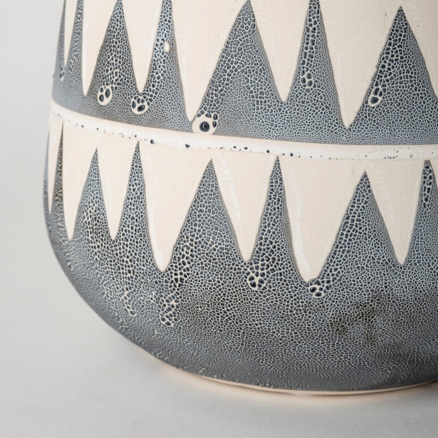 Gray ivory triangle pattern vase showing neutral colors and contemporary geometric style
