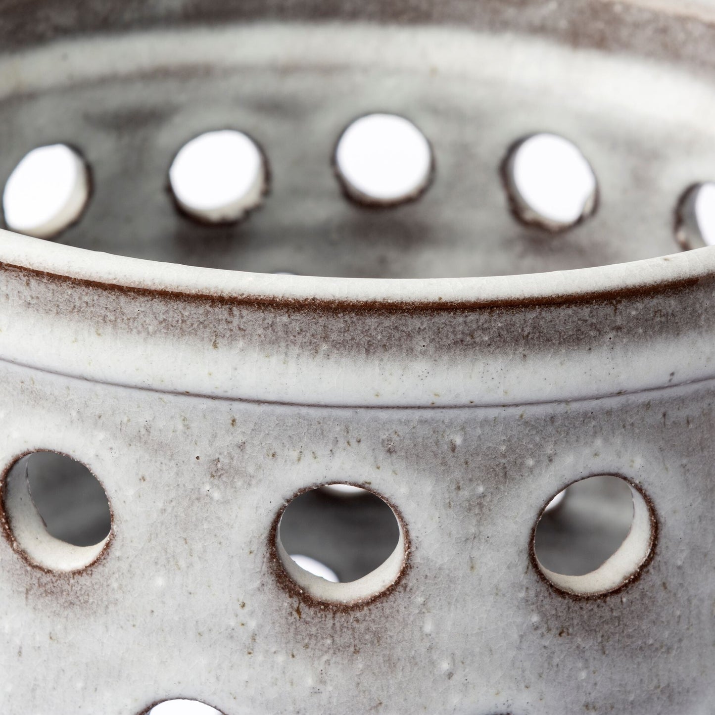 White pierced dot ceramic vase detail showing artisanal craftsmanship and lace-like openwork design