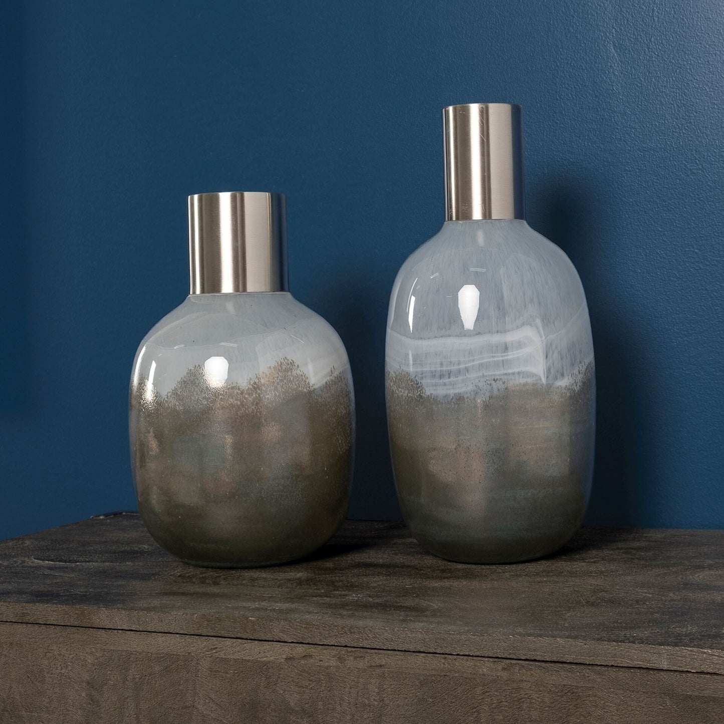 Close-up of premium crystal glass ombre effect and dark bronze metal top on contemporary vase