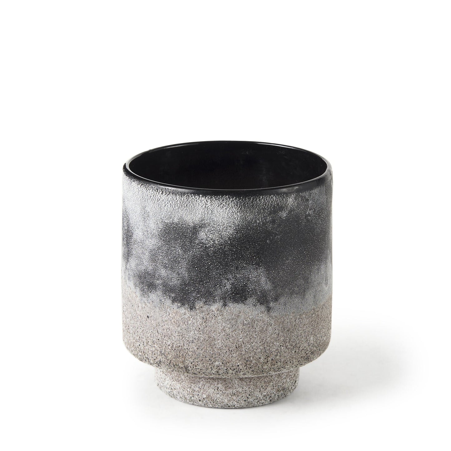 Close-up of ombre gradient from black to brown to gray on textured ceramic vase surface