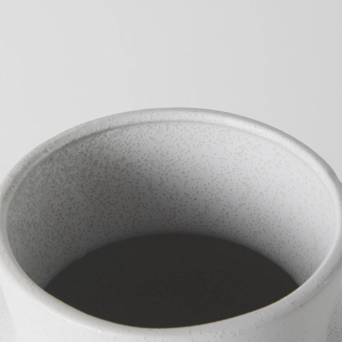 Three-quarter view of 11-inch white ceramic vase emphasizing unique architectural form and elegant proportions, ideal for modern minimalist decor