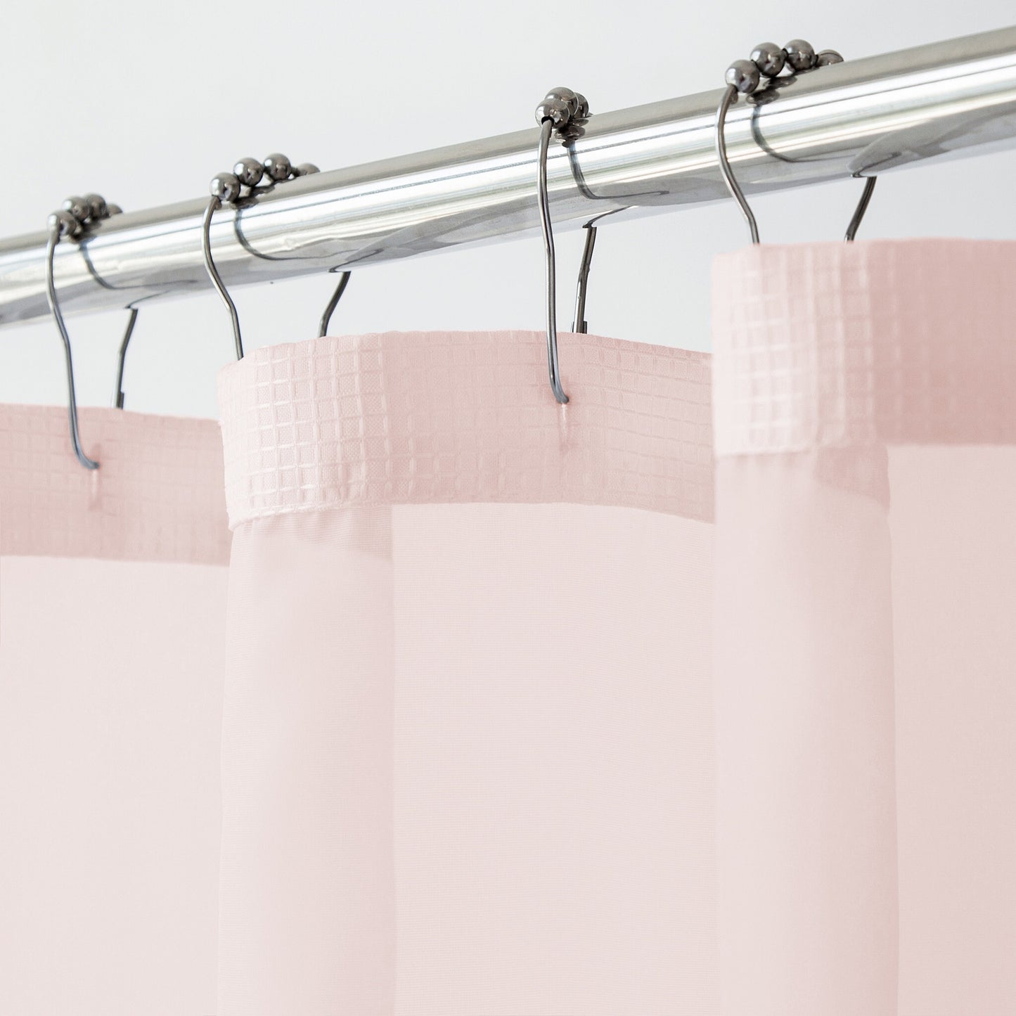 Blush pink shower curtain set with snap-off liner displayed in elegant bathroom setting