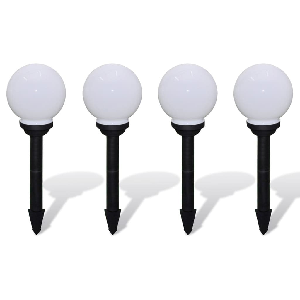 Close-up view of white solar garden lights showing UV-resistant plastic construction and modern spherical shape