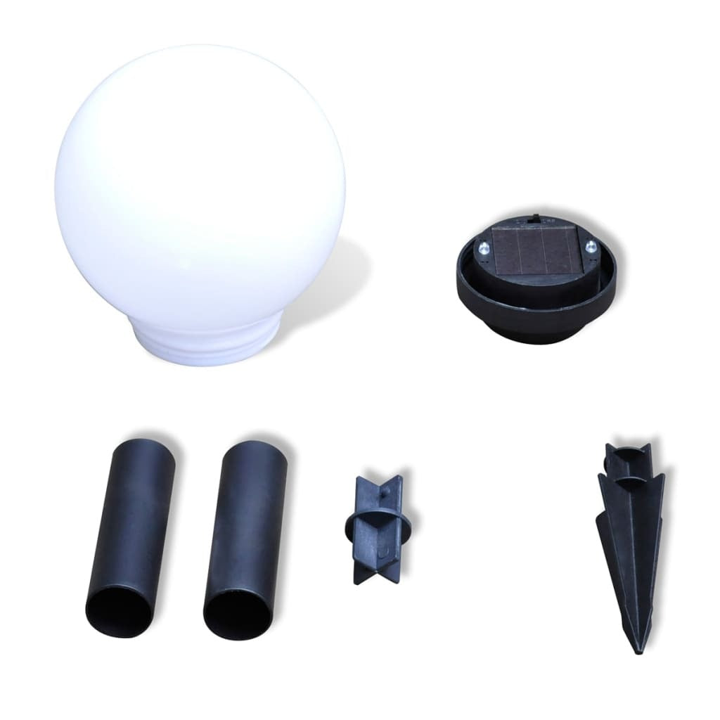 White solar garden lights illuminated at night showing warm white LED glow and automatic lighting function