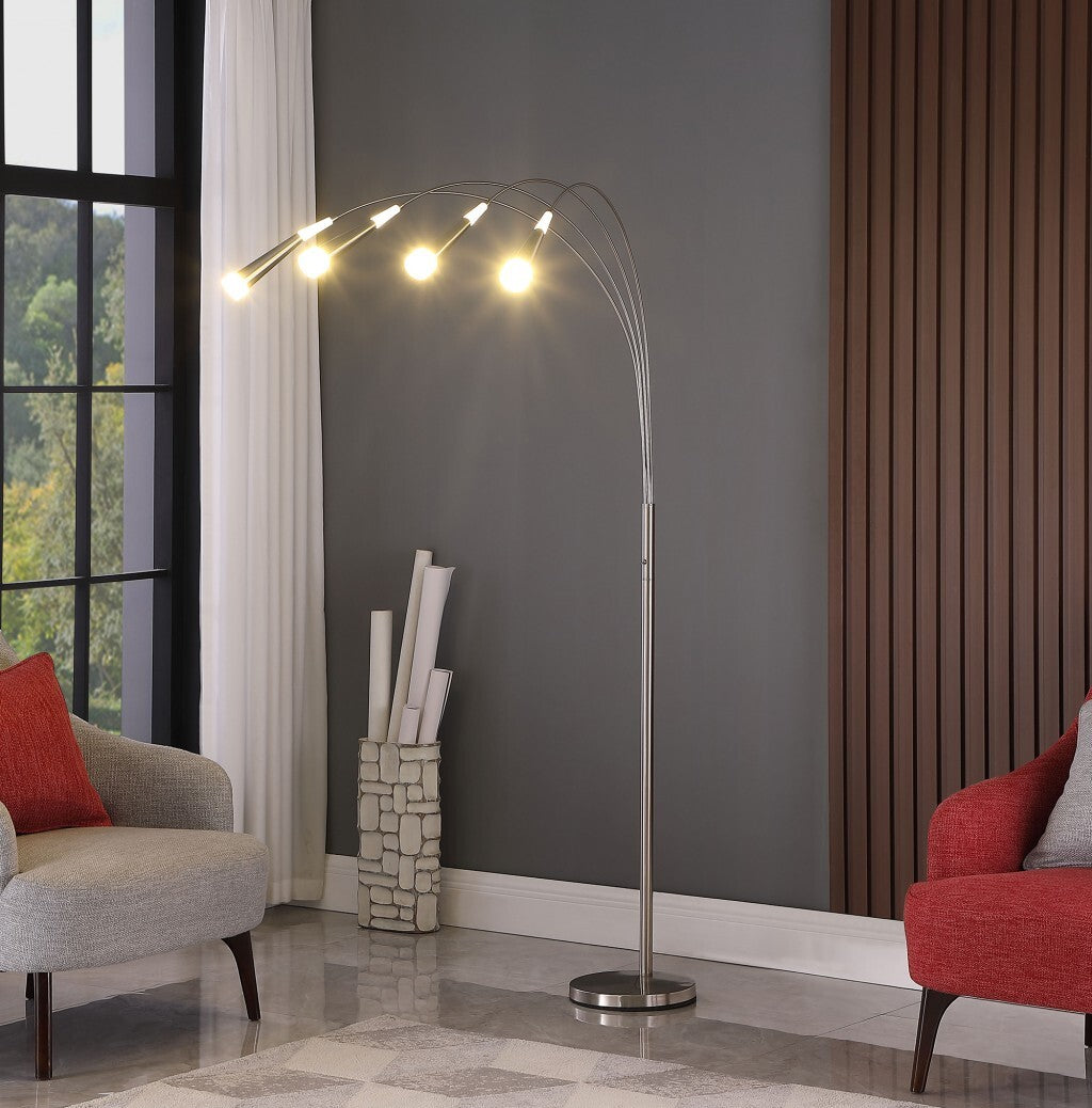 Side view of 72-inch arc floor lamp with polished nickel finish extending over seating area, demonstrating space-saving design