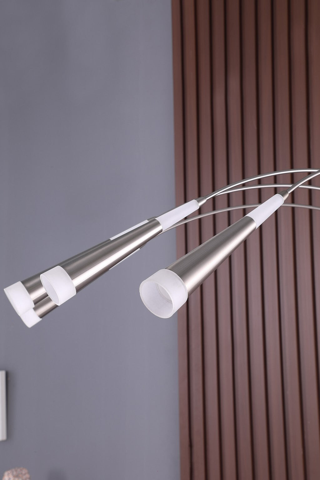 Close-up of polished nickel finish and adjustable light head mechanism on contemporary arc floor lamp