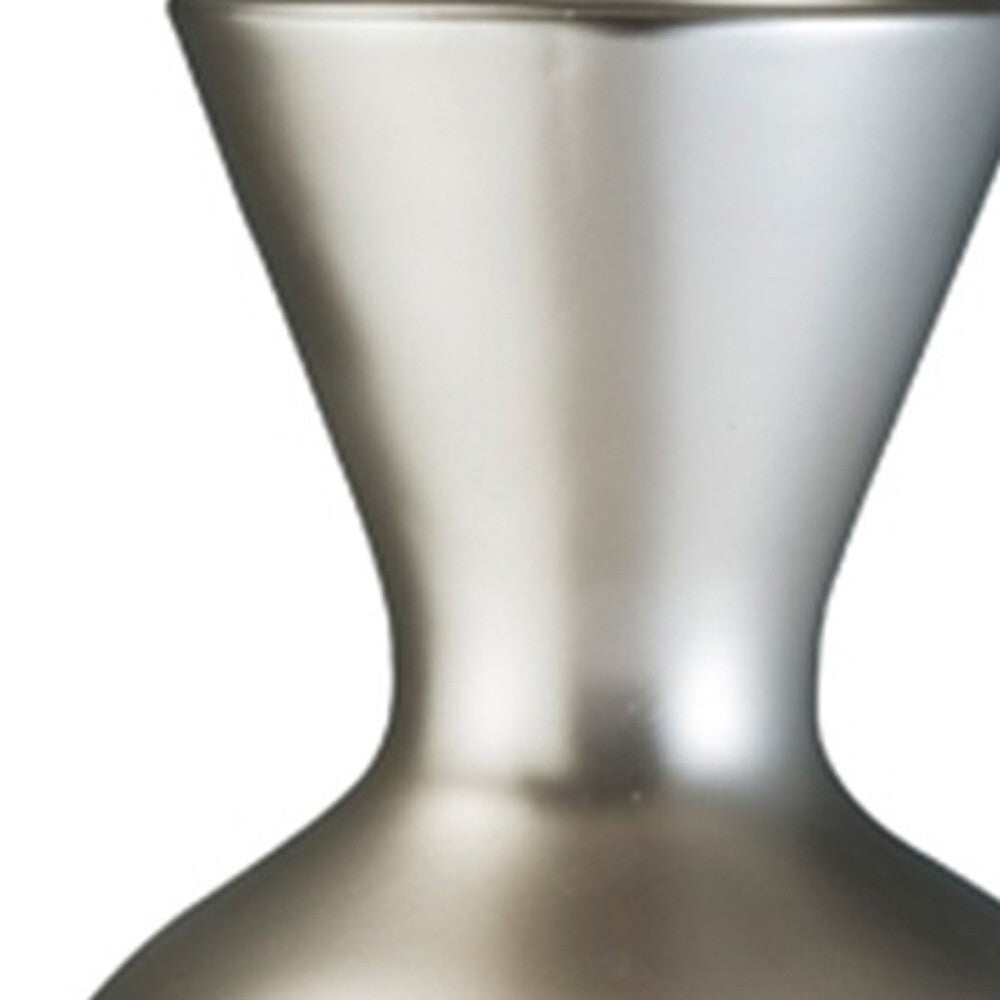 Metallic silver and brown geometric vase on display, designer statement piece for spacious rooms