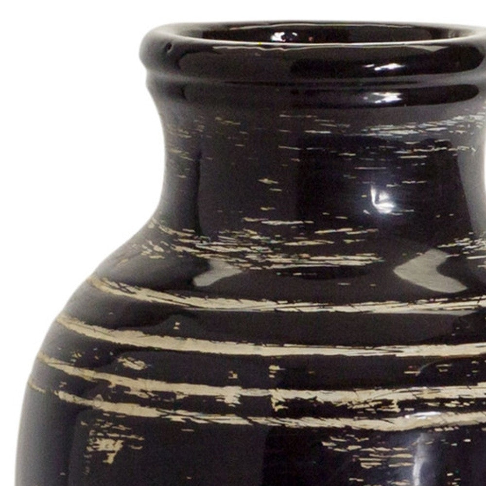 Close-up detail of black and ivory striped pattern on ceramic floor vase showing high-quality craftsmanship and intricate design work