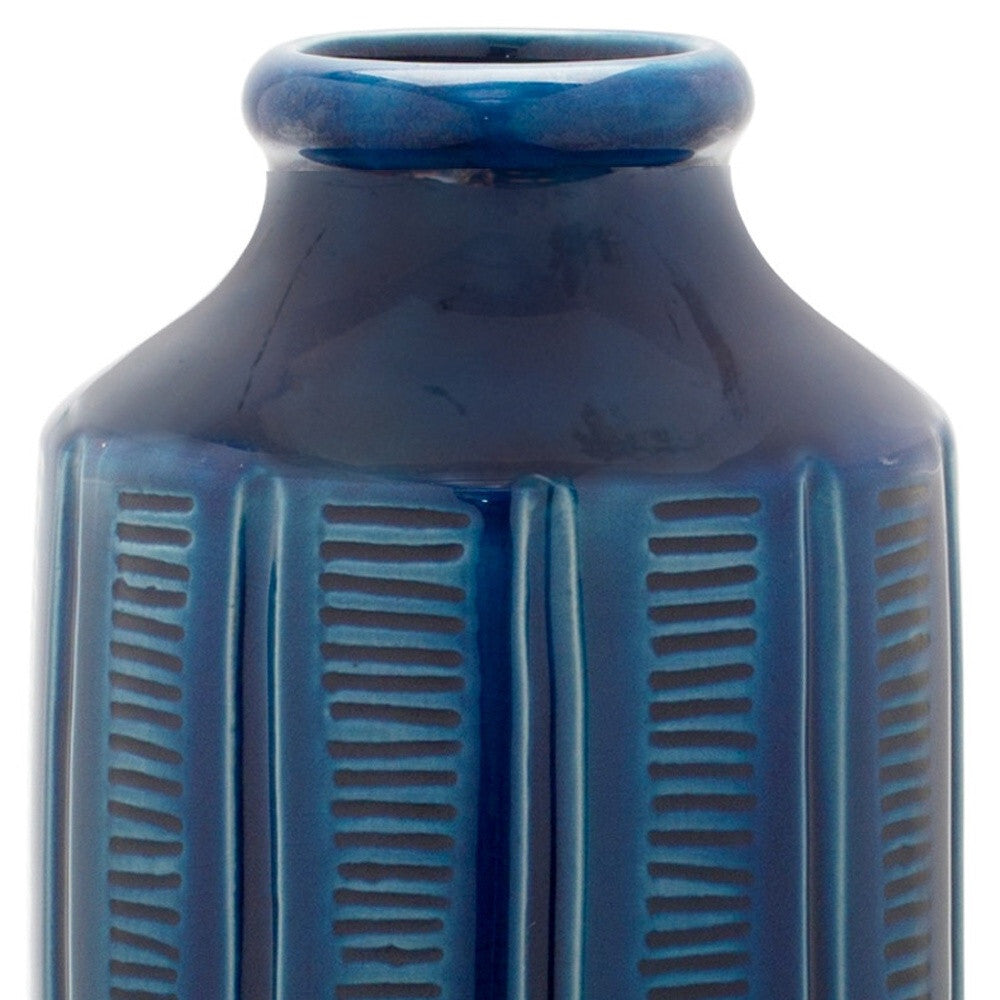Modern blue ribbed terracotta vase with elegant design perfect for flowers and greenery