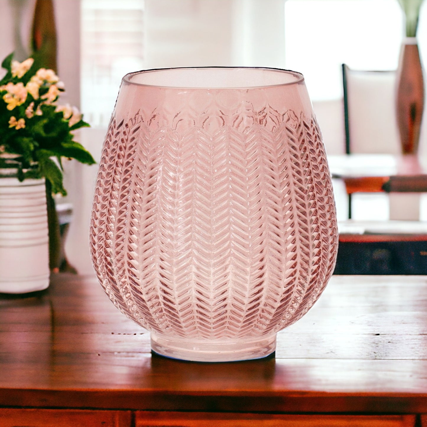 Pink glass vase showing embossed leaf design and romantic translucent color perfect for flowers