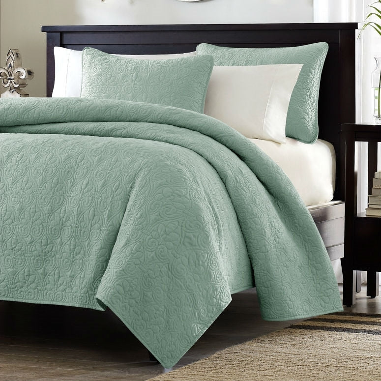 King size seafoam blue quilted coverlet set with floral pattern on modern bed