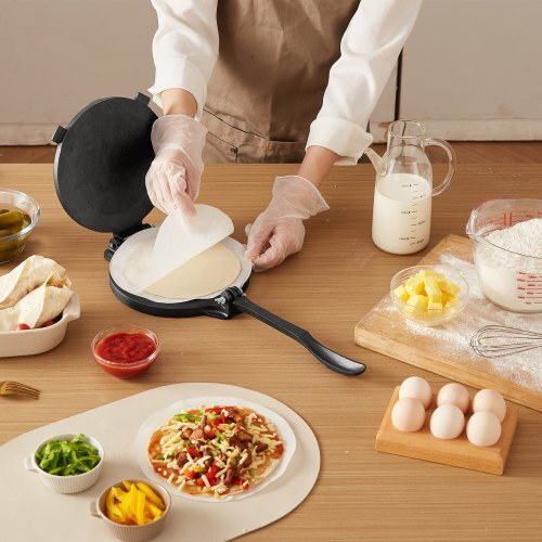 Person making a tortilla with ingredients on a wooden table