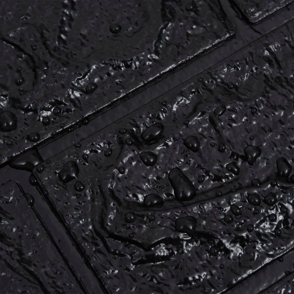 Close-up of a textured black surface with water droplets
