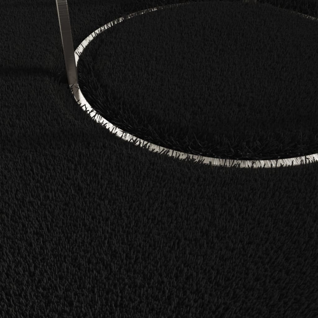 Black area rug in bedroom setting showing 63x90 inch dimensions and versatile home decor styling
