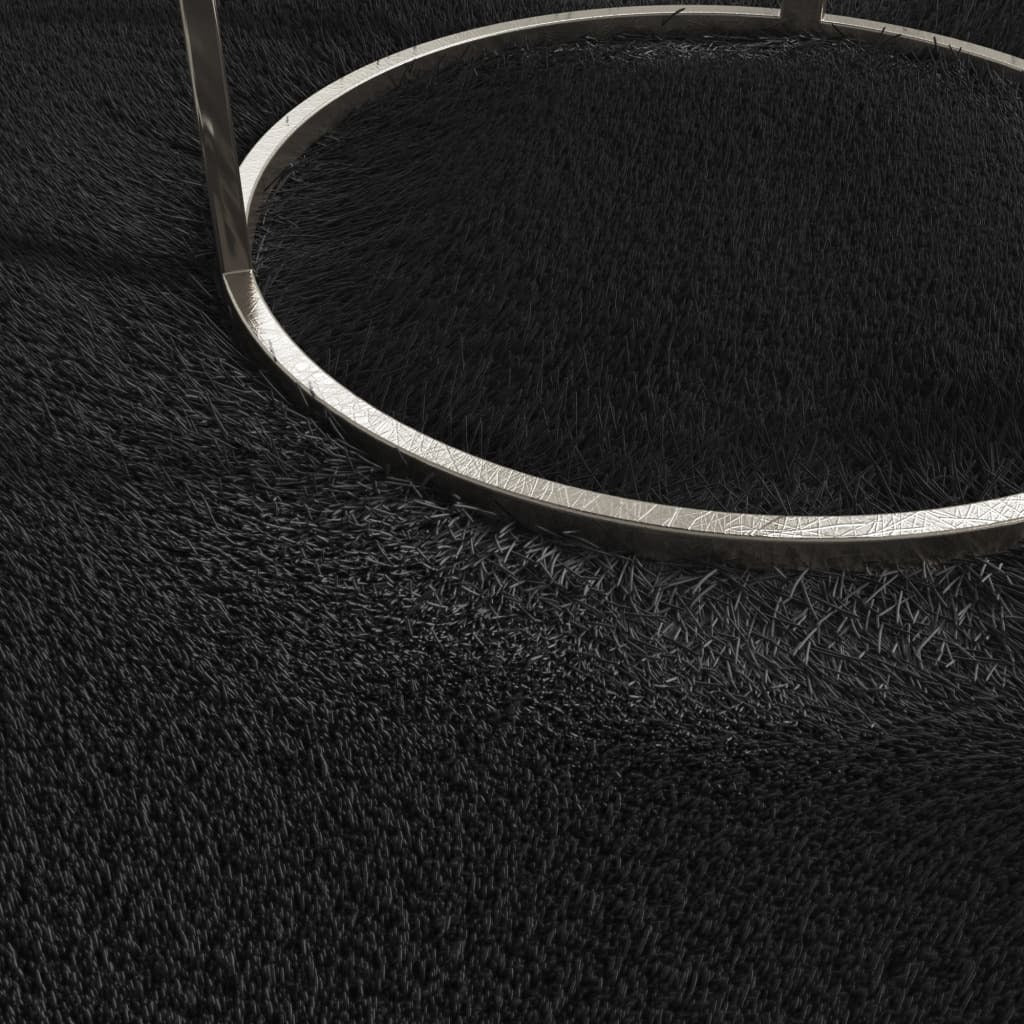 Side view of black rectangular rug showing thickness and plush polyester pile construction

