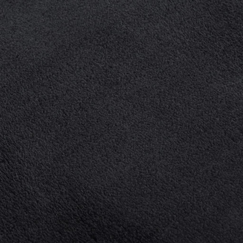 Black rectangular rug in living room decor showing elegant styling and modern interior design
