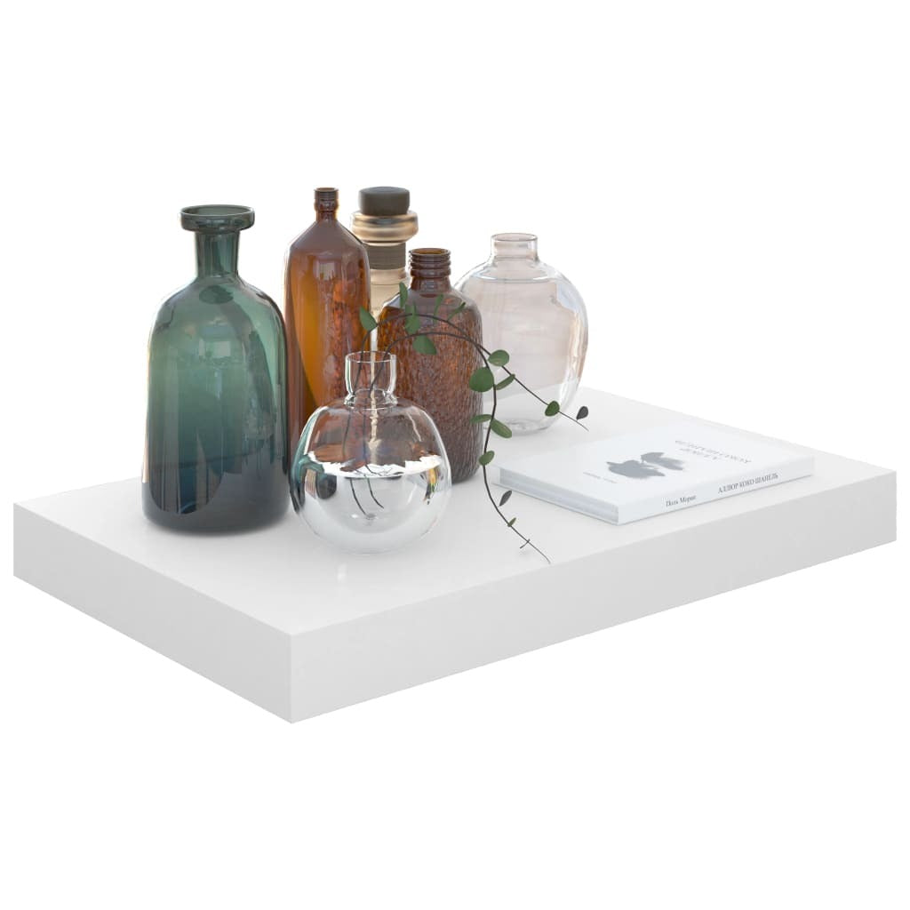 Close-up of single high gloss white floating shelf showing clean minimalist design

