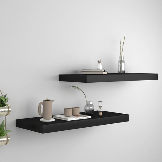 Set of 2 black floating wall shelves with modern minimalist design on white wall
