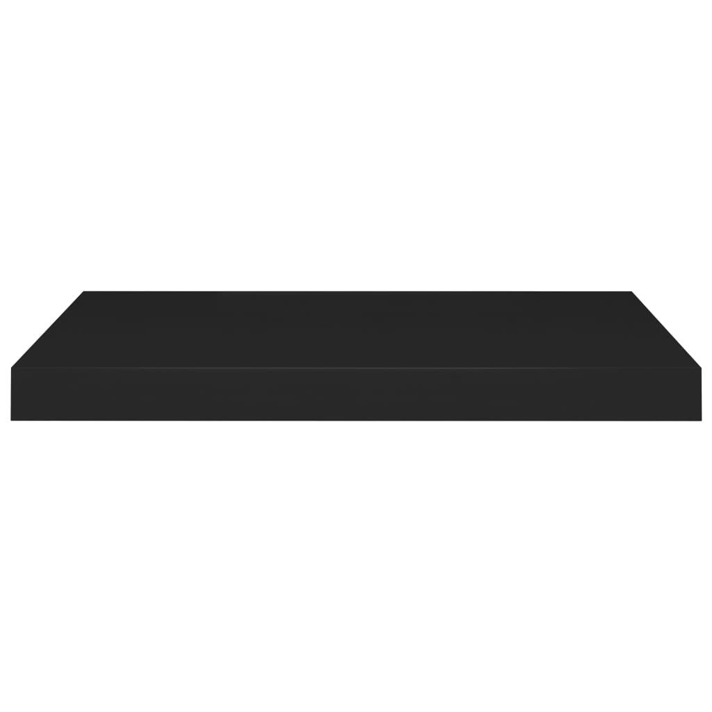 Black floating shelves displaying books plants and decorative objects
