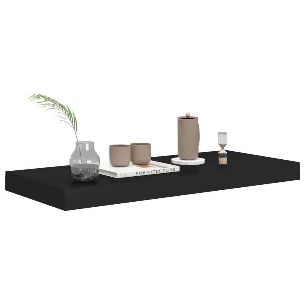 Black floating shelf installation showing hidden bracket mounting system
